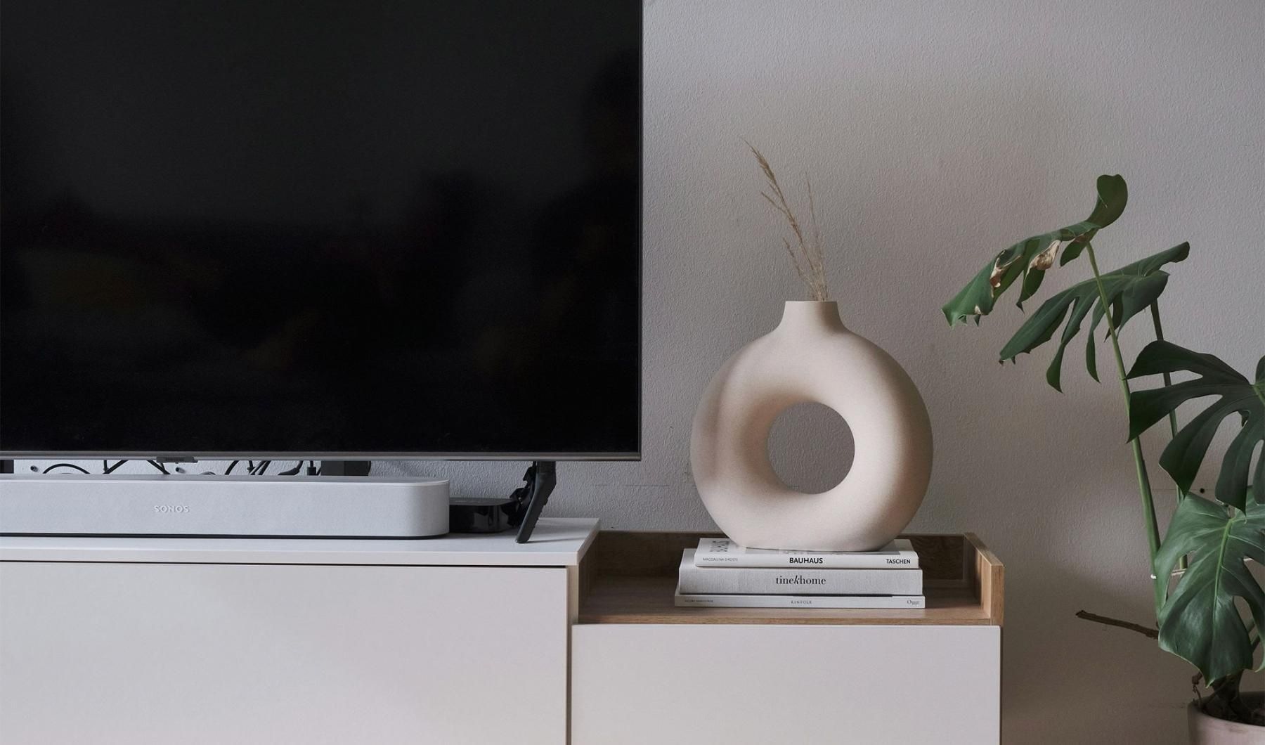 a tv on a stand with decor